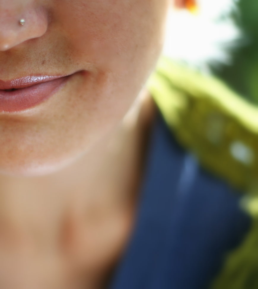 Close-up of Woman's Lips and Nose Piercing Outdoors