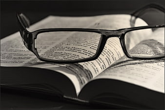 Black Eyeglasses on Open Bible Pages