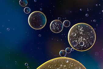 Abstract macro oil droplets in water with golden edges
