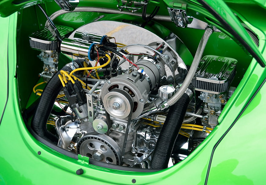 Close-up of a polished green vintage car engine bay