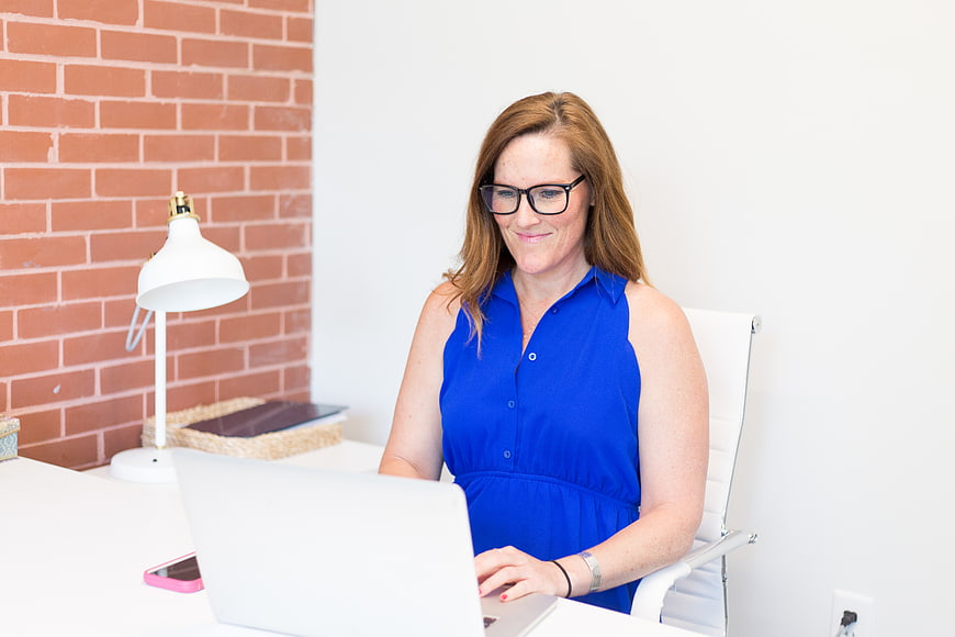 Professional woman working on laptop in modern office