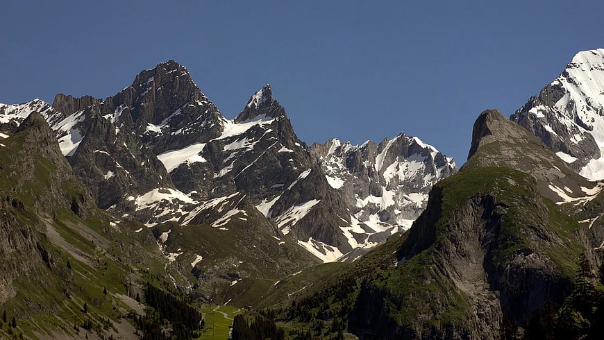 Majestic Snow-Capped Rocky Mountain Peaks with Green Valleys