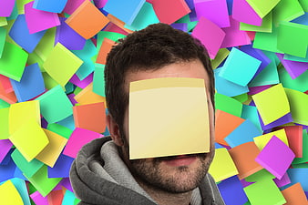 Man with sticky note on face surrounded by colorful post-its