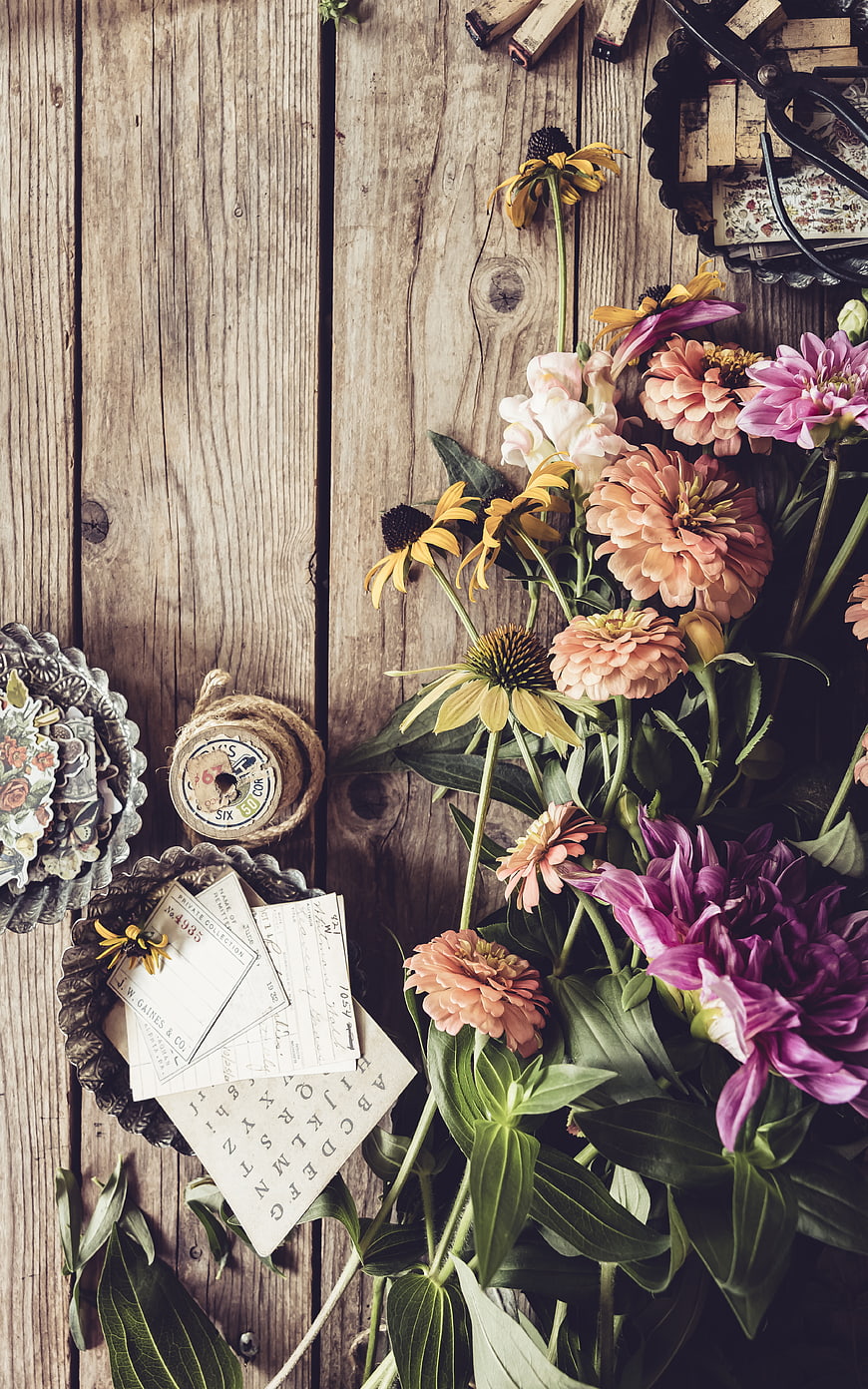 Rustic Flat Lay of Vintage Flowers and Craft Supplies on Wood