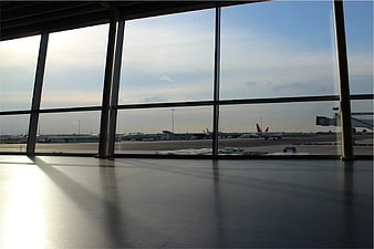 Sunlit airport terminal floor with view of tarmac and airplanes