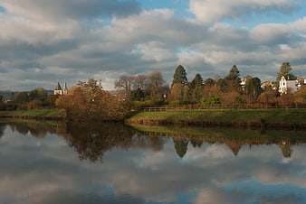 Serene Autumn River Landscape with Church Spire Reflection