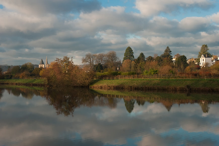 Serene Autumn River Landscape with Church Spire Reflection