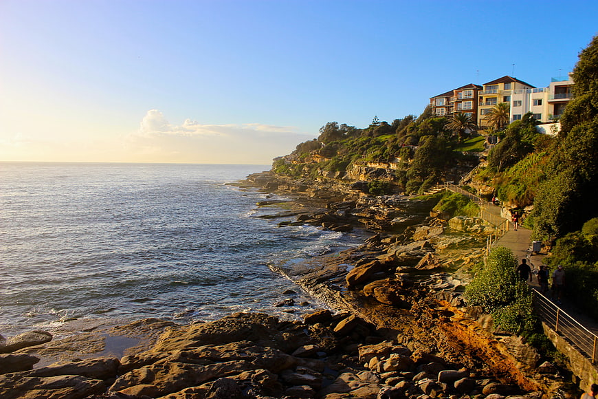 Scenic coastal path with ocean view and cliffside houses