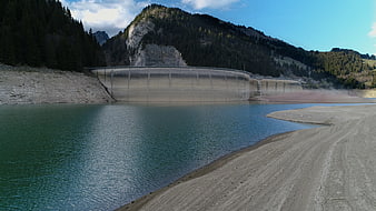 Concrete dam in Swiss Alps with low water levels
