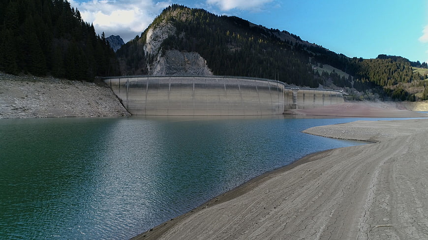 Concrete dam in Swiss Alps with low water levels