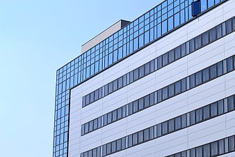 Modern Office Building Facade With Glass Windows And Blue Sky