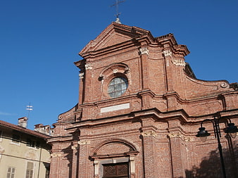 Red Brick Church Facade Against Blue Sky
