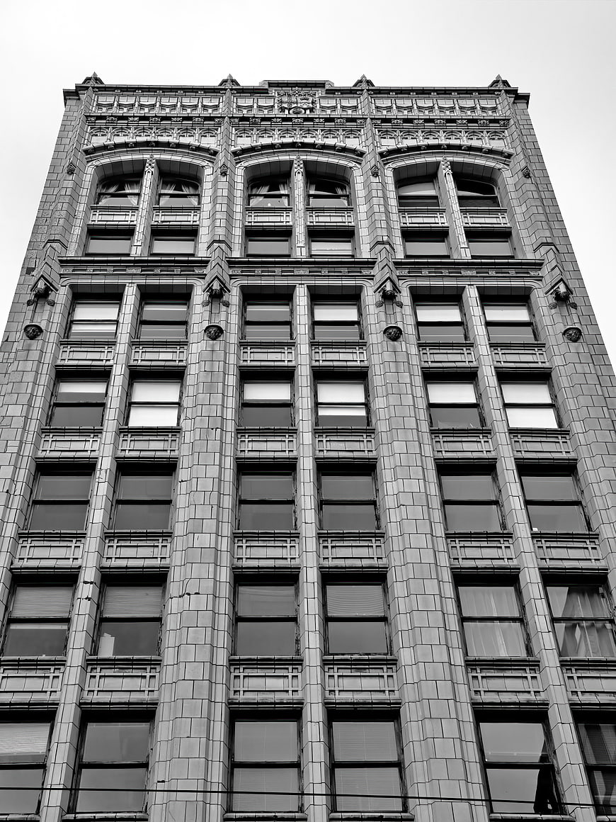 Black and white low angle view of ornate historic building facade