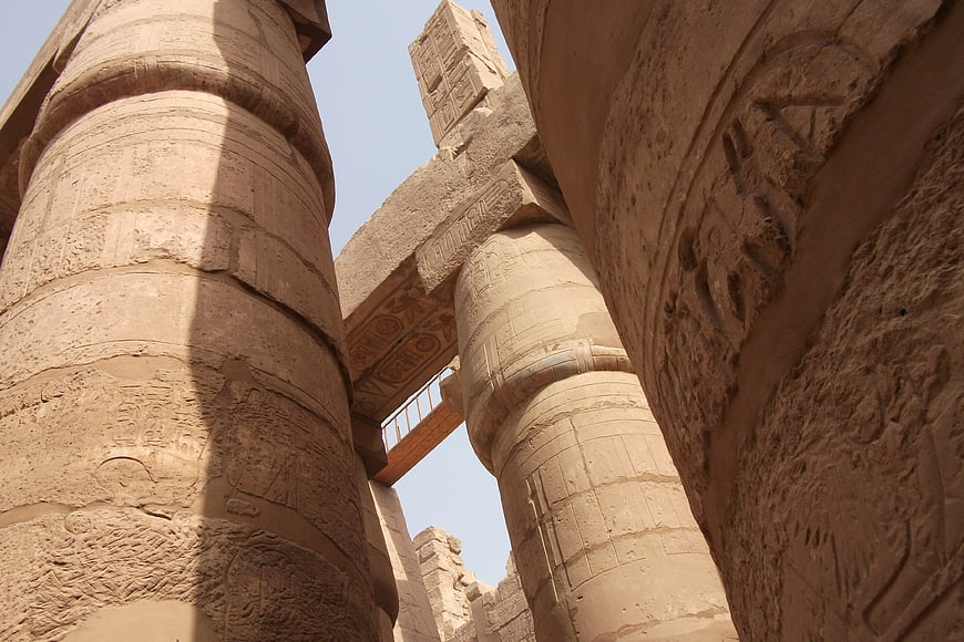 Low angle view of ancient Egyptian temple columns with hieroglyphs