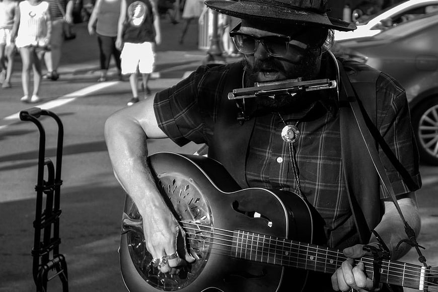 Street Musician Playing Resonator Guitar and Harmonica