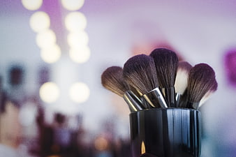 Makeup Brushes in Black Holder with Blurred Vanity Lights