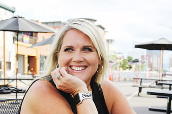 Happy Blonde Woman Smiling at Outdoor Cafe