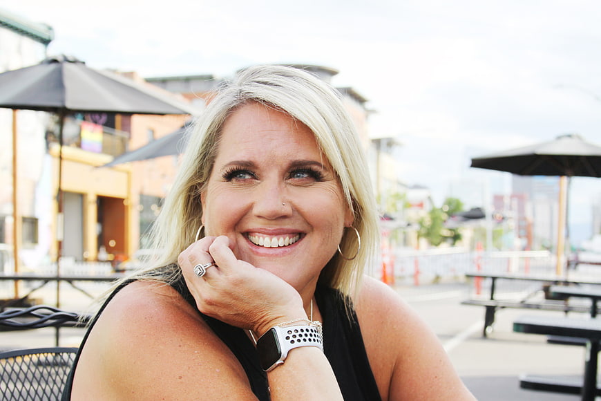 Happy Blonde Woman Smiling at Outdoor Cafe