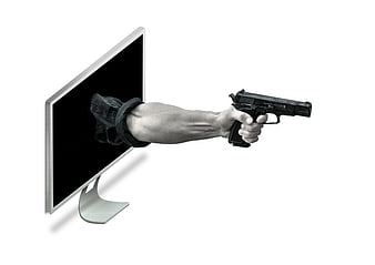 Hand holding gun emerging from computer monitor screen