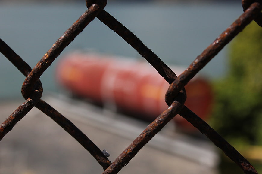 Close up of rusty chain link fence with blurred background