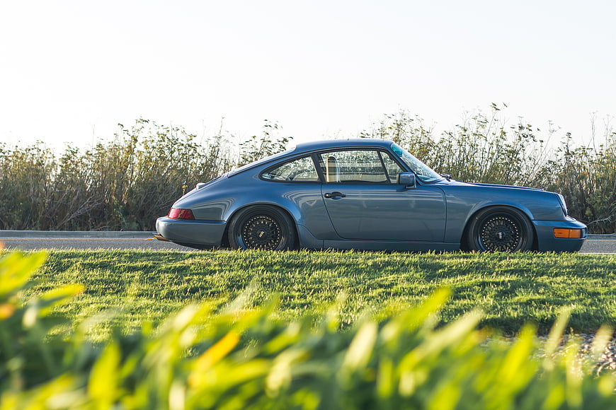 Classic Blue Porsche 911 on Roadside Grass