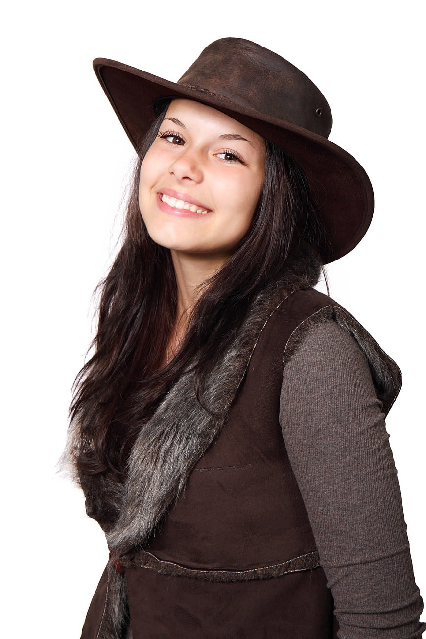 Smiling Woman in Brown Cowboy Hat and Fur Vest