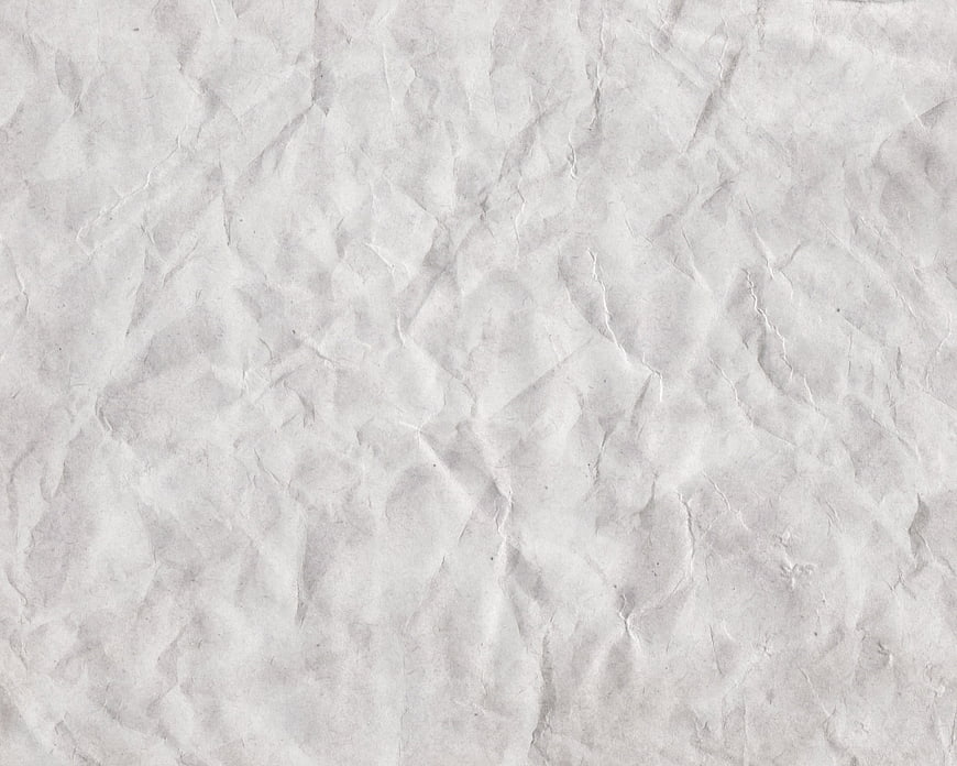 Crumpled white paper texture background with wrinkles and creases
