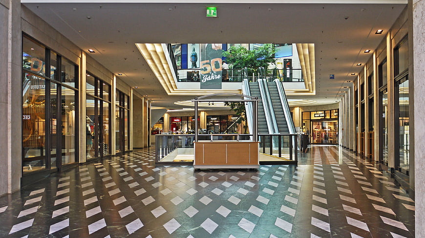 Modern Luxury Shopping Mall Interior With Escalator And Patterned Floor