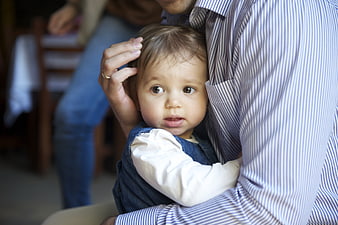Tender Fatherly Hug With Curious Toddler In Denim Outfit
