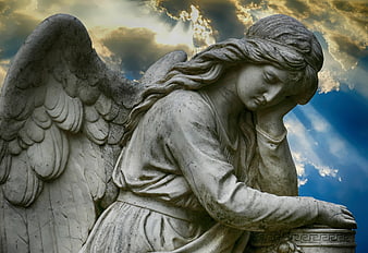Stone Angel Statue with Dramatic Cloudy Sky Background