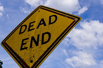 Low Angle View of Weathered Yellow Dead End Road Sign