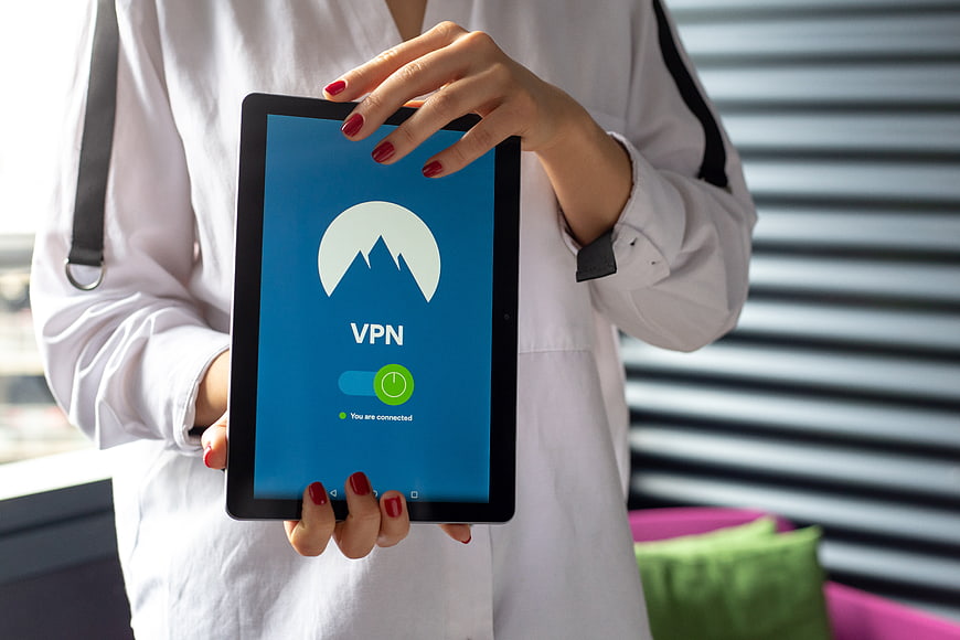 Woman holding tablet with VPN connection interface