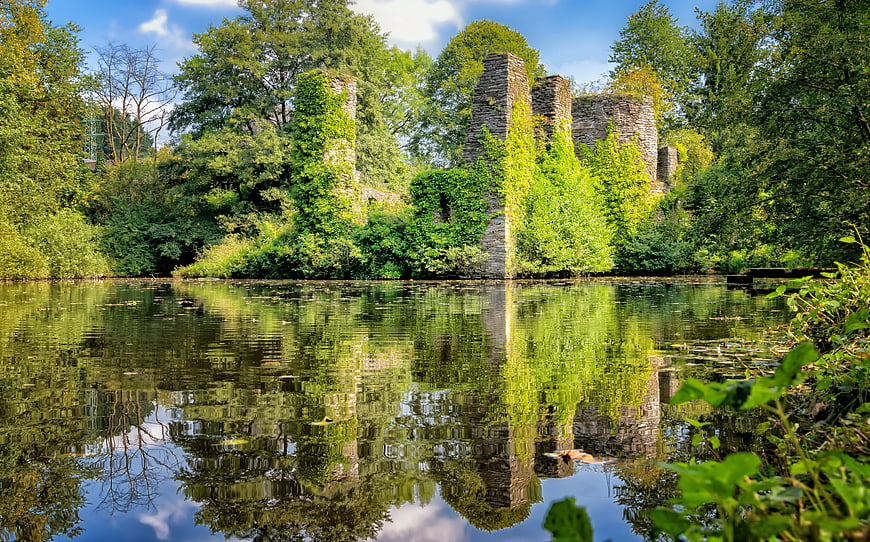 Medieval Castle Ruins Reflected in Calm Lake Water