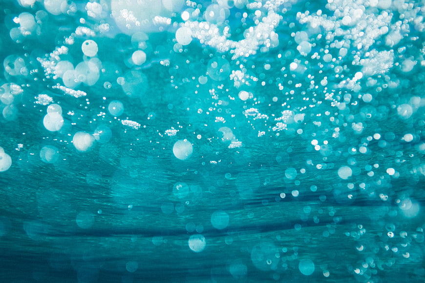 Abstract underwater bubbles with blue bokeh background