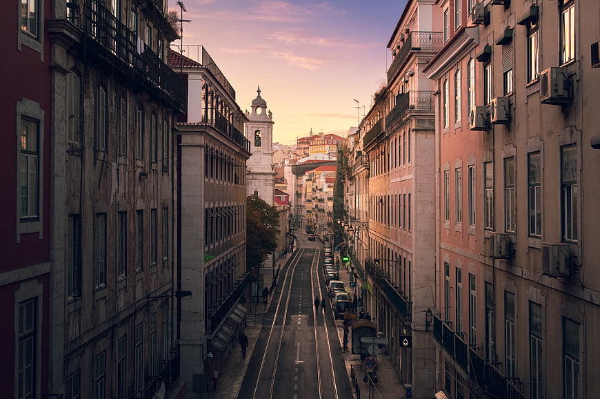 Sunset View of Lisbon Street with Tram Tracks and Historic Buildings