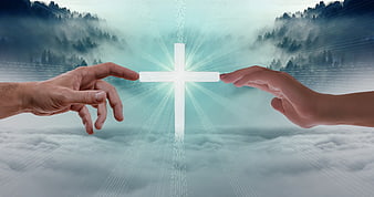 Two hands reaching for a glowing cross above a misty forest landscape