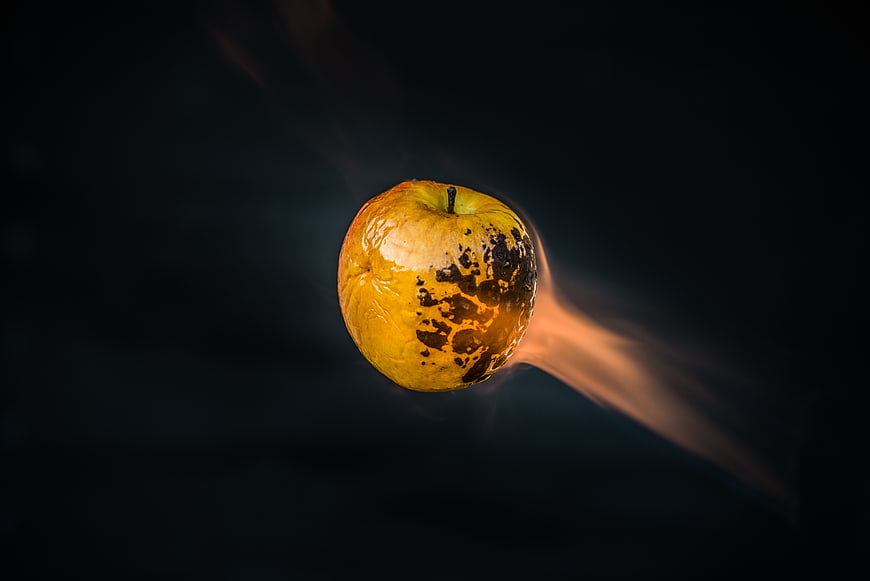 Burning Apple with Flames on Dark Background