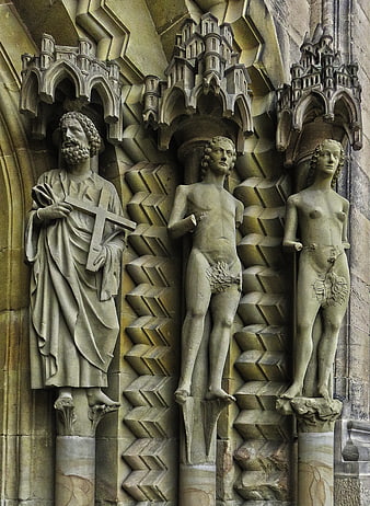 Gothic Stone Sculptures of Adam, Eve, and Saint on Cathedral Portal
