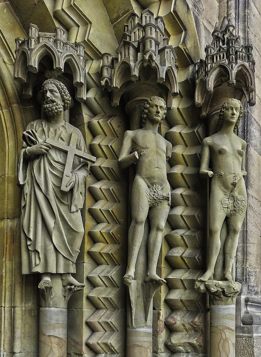 Gothic Stone Sculptures of Adam, Eve, and Saint on Cathedral Portal