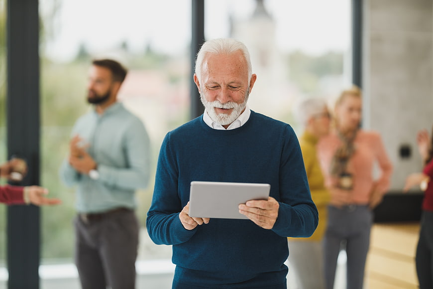 Senior man using tablet in modern office