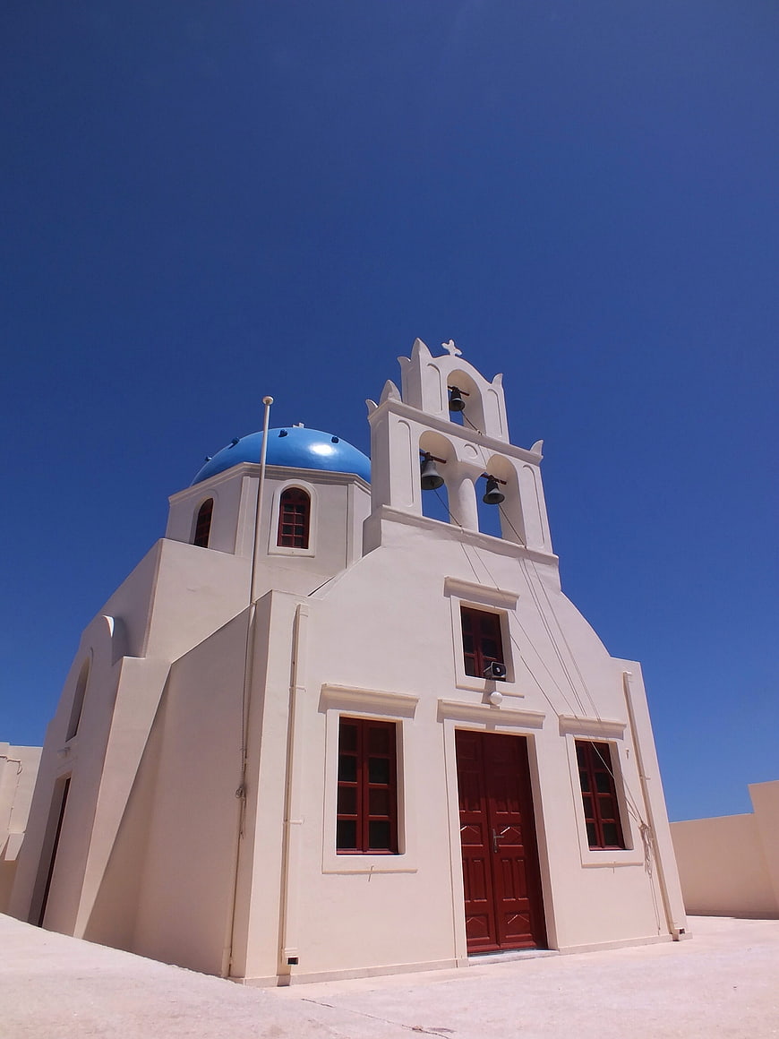 White Greek Orthodox Church with Blue Dome and Bell Tower