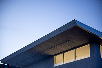 Modern architectural detail with blue sky and warm window light