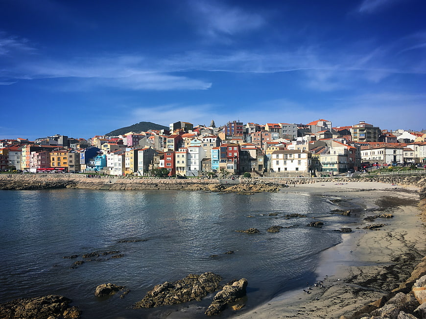 Colorful coastal town on sunny beach with blue sky