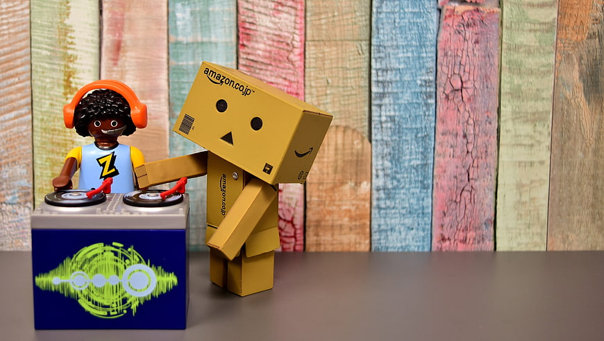 Amazon cardboard robot and DJ figurine with turntable mixer