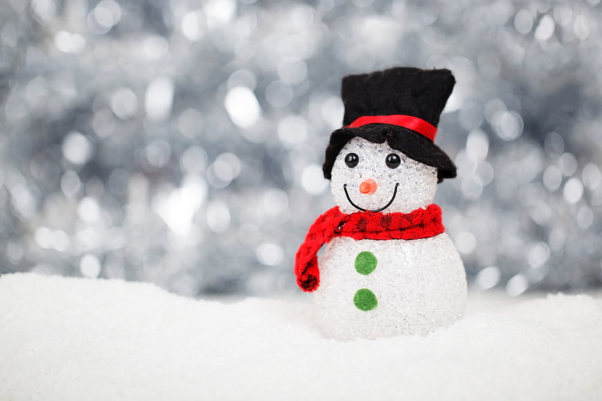 Cute Mini Snowman with Red Scarf and Black Hat on Snow