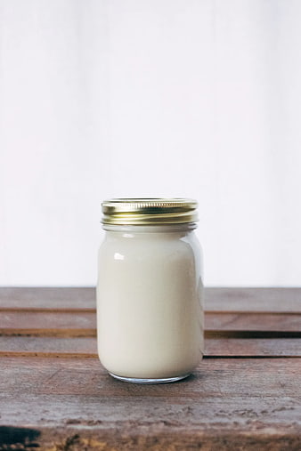 Glass Jar of White Cream on Rustic Wooden Table