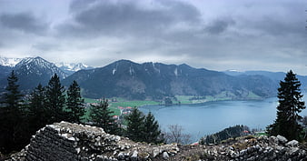Panoramic Alpine Lake View with Snowy Mountains and Stone Ruins