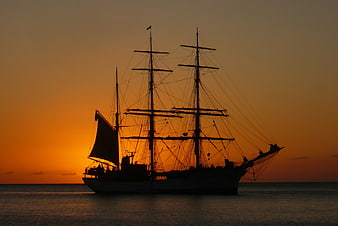 Silhouette of a Tall Ship at Sunset on the Ocean