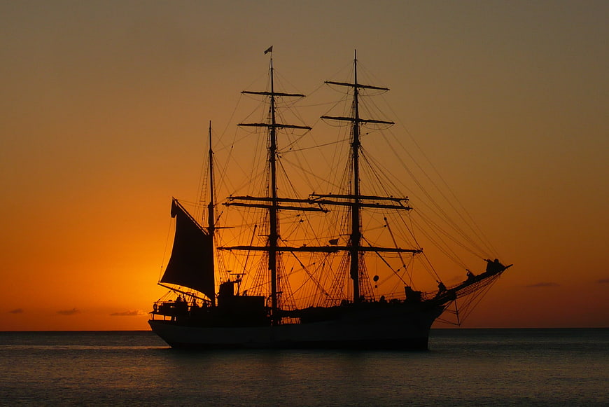 Silhouette of a Tall Ship at Sunset on the Ocean