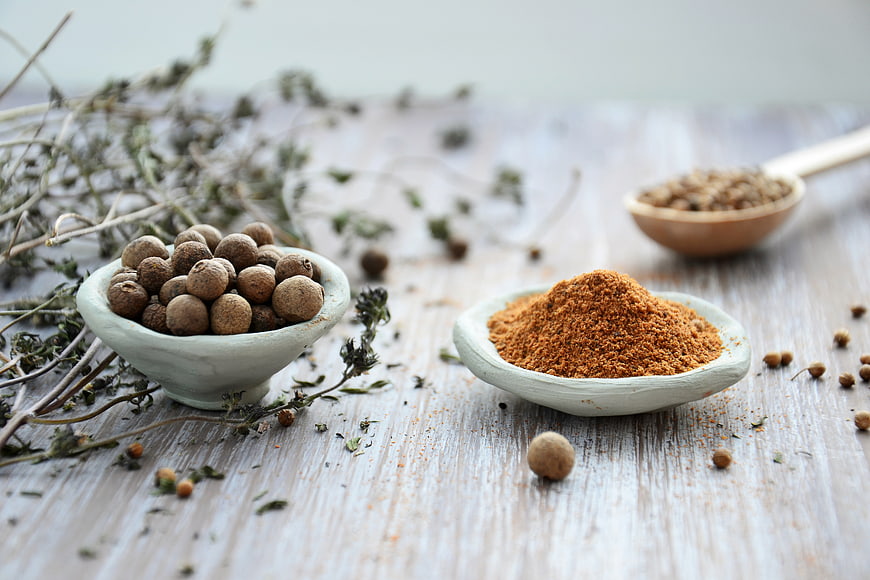 Dried spices and herbs on rustic wooden table